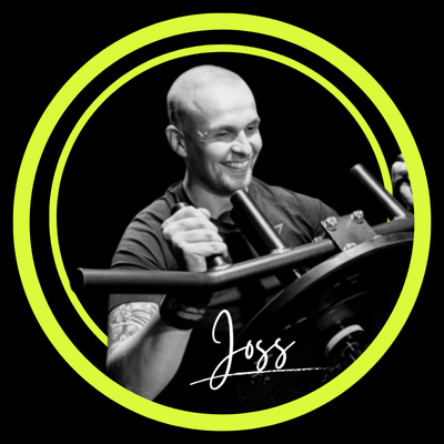 Coach Joss smiling using gym equipment 