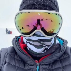 Debbie standing in snowy conditions wearing ski goggles